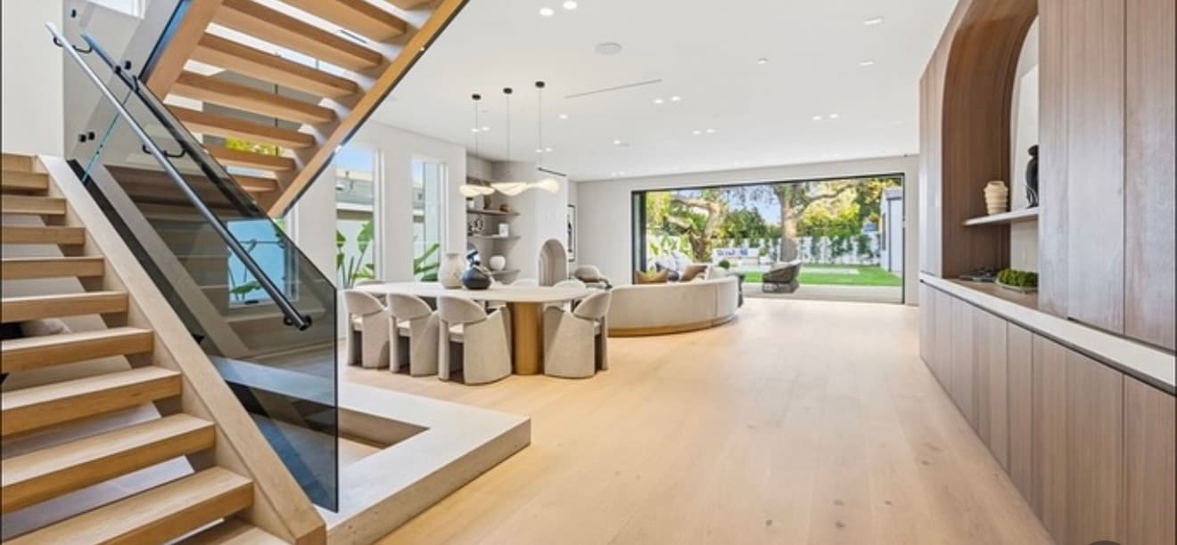 Open-concept living space with floating staircase